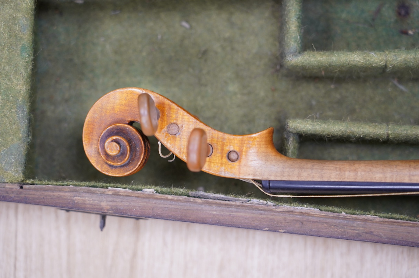 A late 19th century German violin, bearing a Stradivarius label, dated 1717, with mother of pearl inlaid tailpiece, in a walnut case and with bow, the bow stamped Vuillaume & Paris. Condition - fair